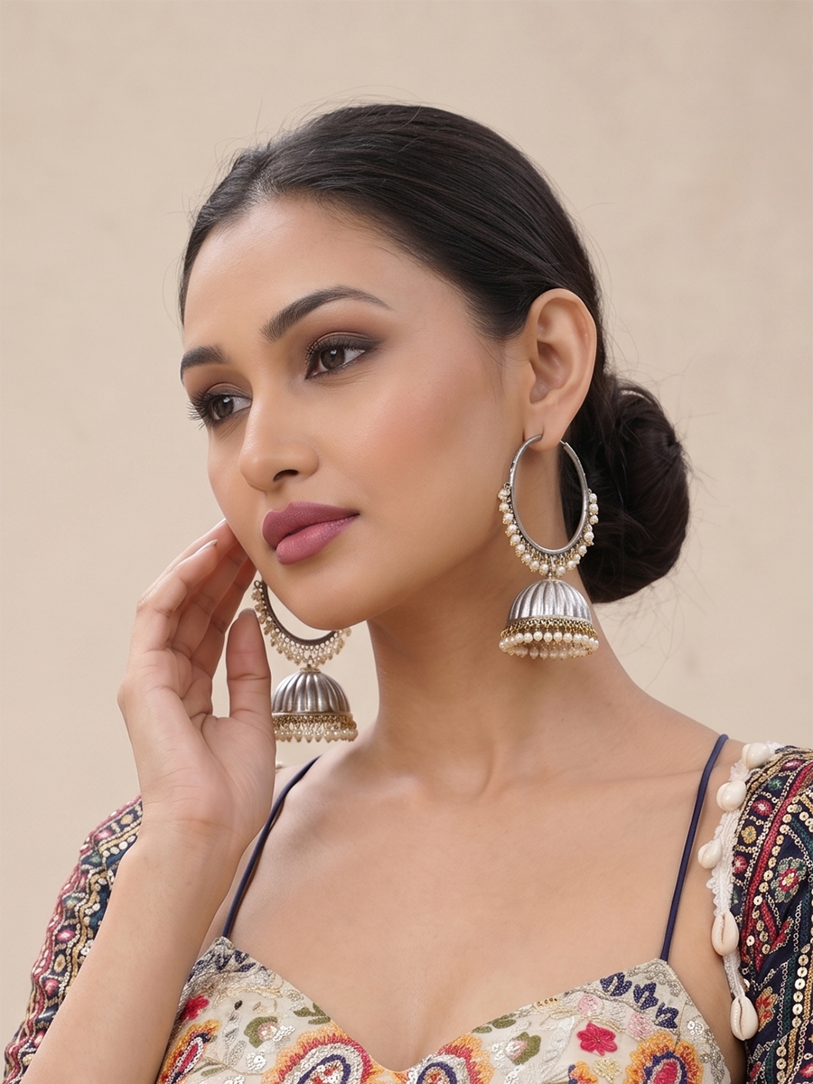 Silver jhumka earrings with white pearls.