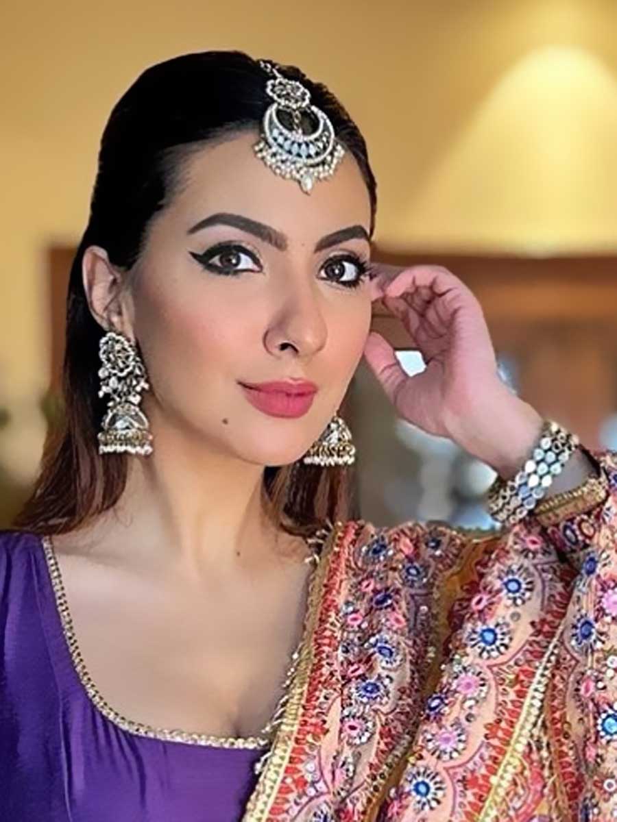 Women in traditional attire, wearing earrings and bangle.