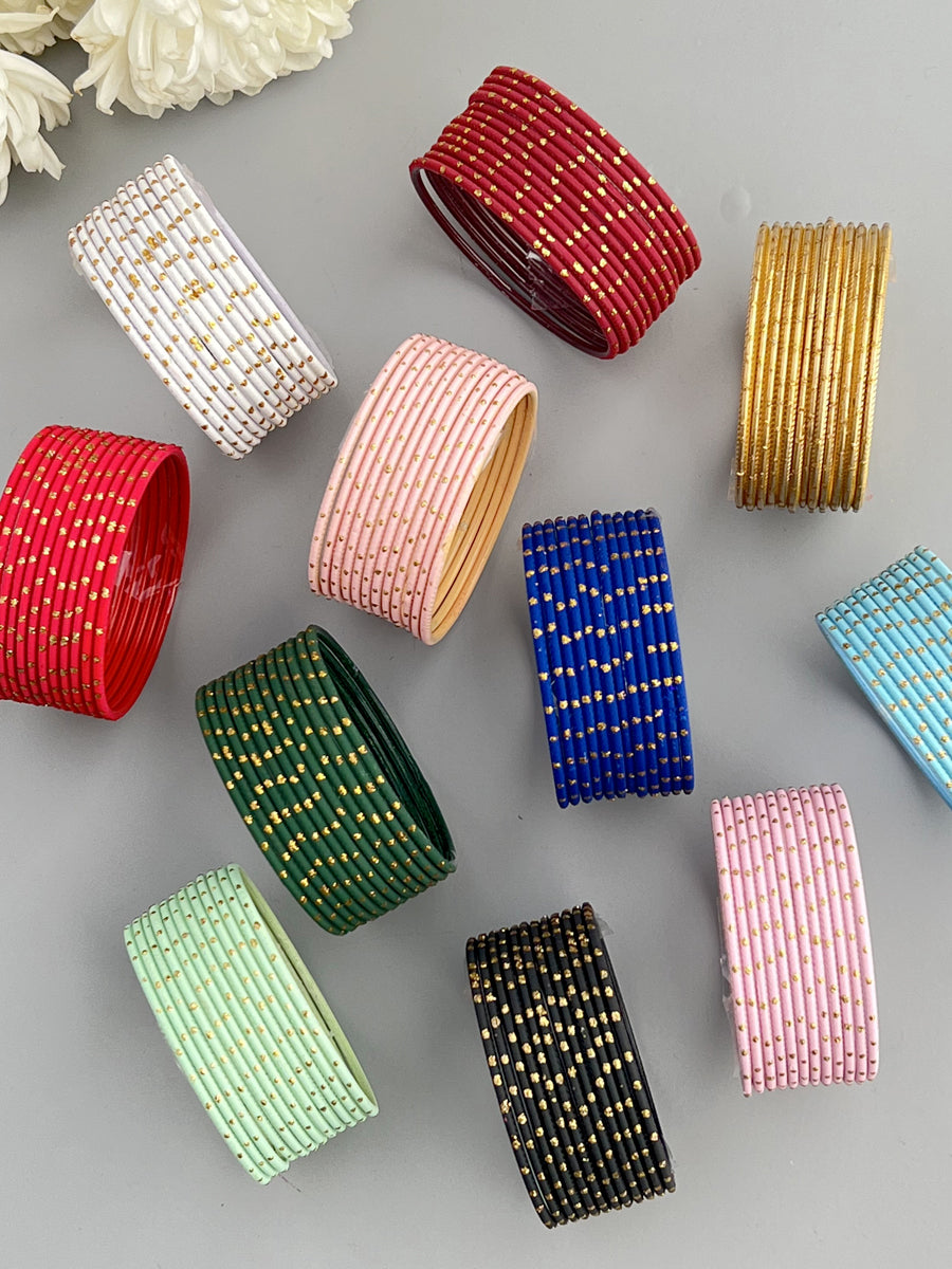 A set of 12 multicolored matte finish bangle bracelets with glitter, displayed on a neutral background.