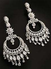 Intricate diamond chandelier earrings displayed against a black background.